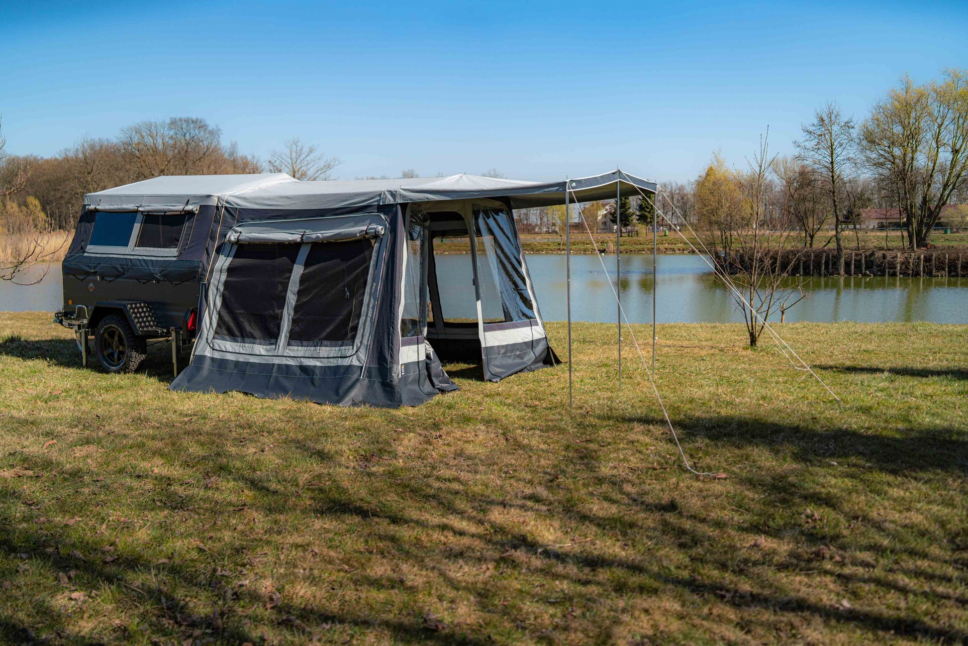 Komplettansicht eines vollständig aufgebauten Klappcampers mit Vorzelt und Sonnensegel in der Offroad-Variante